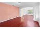 Spacious living room featuring wood floors, arched entryway, and decorative chandelier at 7711 Nottinghill Sky Dr, Apollo Beach, FL 33572