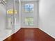 Open living room with high ceilings, large windows, and hardwood floors at 7711 Nottinghill Sky Dr, Apollo Beach, FL 33572
