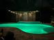 Screened pool with colored lights and string lights at 7711 Nottinghill Sky Dr, Apollo Beach, FL 33572