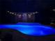 Screened pool with colored lights and string lights at 7711 Nottinghill Sky Dr, Apollo Beach, FL 33572