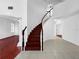 Elegant curved staircase with hardwood steps and white spindles at 7711 Nottinghill Sky Dr, Apollo Beach, FL 33572