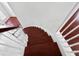 Elegant curved staircase with wood steps and white railing at 7711 Nottinghill Sky Dr, Apollo Beach, FL 33572