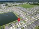 An aerial view showing a neighborhood pond with a fountain at 7774 Sail Clover Ln, Zephyrhills, FL 33540