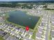 Overhead view of the home situated near a pond in a quiet neighborhood at 7774 Sail Clover Ln, Zephyrhills, FL 33540