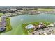 Aerial view of community pool, amenity center, and lake at 7774 Sail Clover Ln, Zephyrhills, FL 33540
