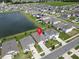 Neighborhood aerial view features a lake view and well-maintained landscaping at 7774 Sail Clover Ln, Zephyrhills, FL 33540