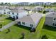 Spacious backyard offers a covered patio, a white fence and lush lawn at 7774 Sail Clover Ln, Zephyrhills, FL 33540