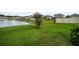 Beautiful backyard with view of a pond and blossoming trees at 7774 Sail Clover Ln, Zephyrhills, FL 33540