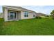 Backyard with lush lawn, patio and view of the lake at 7774 Sail Clover Ln, Zephyrhills, FL 33540