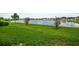 A lush backyard with a waterfront view of the community lake with fountain at 7774 Sail Clover Ln, Zephyrhills, FL 33540