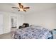 Bedroom with ceiling fan and view to the bathroom at 7774 Sail Clover Ln, Zephyrhills, FL 33540