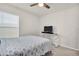 Light and airy bedroom with large window and neutral walls at 7774 Sail Clover Ln, Zephyrhills, FL 33540