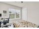 Bright bedroom with a work space by the window and neutral walls and flooring at 7774 Sail Clover Ln, Zephyrhills, FL 33540