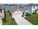 Charming home showcasing a manicured lawn and an attached two-car garage at 7774 Sail Clover Ln, Zephyrhills, FL 33540