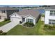 Well-kept home with a lush green lawn, landscaped beds and an attached garage at 7774 Sail Clover Ln, Zephyrhills, FL 33540