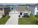 Beautiful home boasts manicured landscaping and a cozy two-car garage at 7774 Sail Clover Ln, Zephyrhills, FL 33540