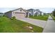 This single-story home features a well manicured lawn and landscaping, and a spacious two-car garage at 7774 Sail Clover Ln, Zephyrhills, FL 33540