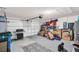 A spacious two car garage equipped with a grill, storage, and large overhead door at 7774 Sail Clover Ln, Zephyrhills, FL 33540