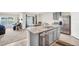 Open kitchen featuring stainless steel appliances, a granite countertop island, and an eat-in dining area at 7774 Sail Clover Ln, Zephyrhills, FL 33540