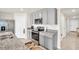 This spacious kitchen features stainless steel appliances, granite countertops, and grey cabinets at 7774 Sail Clover Ln, Zephyrhills, FL 33540