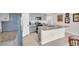 Modern kitchen with granite countertops, stainless steel appliances, a kitchen island, and tiled floors at 7774 Sail Clover Ln, Zephyrhills, FL 33540