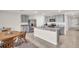 Well-lit kitchen features granite countertops, stainless steel appliances, and gray cabinets at 7774 Sail Clover Ln, Zephyrhills, FL 33540