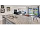 View from the kitchen of the open-concept living room, with a dining area and water views at 7774 Sail Clover Ln, Zephyrhills, FL 33540