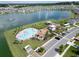 Aerial view of the community pool, clubhouse, playground, and ample parking, perfect for recreation at 7774 Sail Clover Ln, Zephyrhills, FL 33540