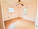Bedroom with two windows, ceiling fan, and vinyl floors, ideal for personalization at 7908 Croton Ave, Tampa, FL 33619