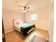 Cozy bedroom with a ceiling fan, a bed, and a window offering natural light and comfort at 7908 Croton Ave, Tampa, FL 33619