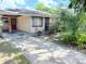 This cozy house boasts a brick exterior and a paved driveway at 7908 Croton Ave, Tampa, FL 33619