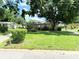 Charming single-story home featuring a lush front lawn and mature shade tree at 7908 Croton Ave, Tampa, FL 33619