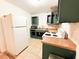 The kitchen includes a refrigerator, cabinets, countertops, sink, microwave, and oven at 7908 Croton Ave, Tampa, FL 33619