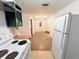 Bright kitchen with white appliances, green cabinets, and eat-in space, ready for customization and renovation at 7908 Croton Ave, Tampa, FL 33619