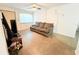 The living room features a sofa, ceiling fan, window, and a smooth floor at 7908 Croton Ave, Tampa, FL 33619