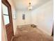 Bright, white living room with vintage chandelier, blank canvas awaiting its new design at 7908 Croton Ave, Tampa, FL 33619