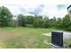Lush backyard featuring green grass, mature trees and landscaping providing privacy and a peaceful setting at 8050 Diablo Ct, Trinity, FL 34655