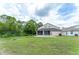 Expansive backyard featuring green grass, mature trees and landscaping providing privacy at 8050 Diablo Ct, Trinity, FL 34655