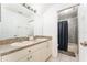 Well-lit bathroom with a double sink vanity and a separate shower/tub combination for convenience at 8050 Diablo Ct, Trinity, FL 34655