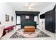 Comfortable bedroom features a dark green bed, decorative rug, and ample natural light at 8050 Diablo Ct, Trinity, FL 34655