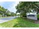 Community entrance featuring a decorative sign, lush landscaping, and a secure gated entry at 8050 Diablo Ct, Trinity, FL 34655