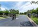 Elegant gated entrance to a community featuring well-maintained landscaping and secure access at 8050 Diablo Ct, Trinity, FL 34655