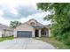 Inviting two-story home with a spacious two-car garage and welcoming front porch at 8050 Diablo Ct, Trinity, FL 34655