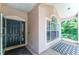 Welcoming front porch featuring stylish tile flooring and a charming window detail at 8050 Diablo Ct, Trinity, FL 34655
