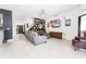 Spacious living room features tile flooring, a wall-mounted TV, and an eclectic mix of decor at 8050 Diablo Ct, Trinity, FL 34655