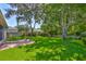 Spacious backyard with a well-manicured lawn, patio and mature trees at 8213 Swann Hollow Dr, Tampa, FL 33647