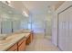 Bright bathroom with double sink vanity, soaking tub, and separate shower, with natural light from a window at 8213 Swann Hollow Dr, Tampa, FL 33647