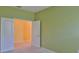 Spacious carpeted room with a doorway featuring tiled floor, providing a versatile living space at 8213 Swann Hollow Dr, Tampa, FL 33647