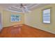 Large bedroom with trey ceilings, hardwood floors, and large window at 8213 Swann Hollow Dr, Tampa, FL 33647