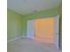 Bright bedroom featuring neutral carpet, fresh paint, and an open doorway at 8213 Swann Hollow Dr, Tampa, FL 33647